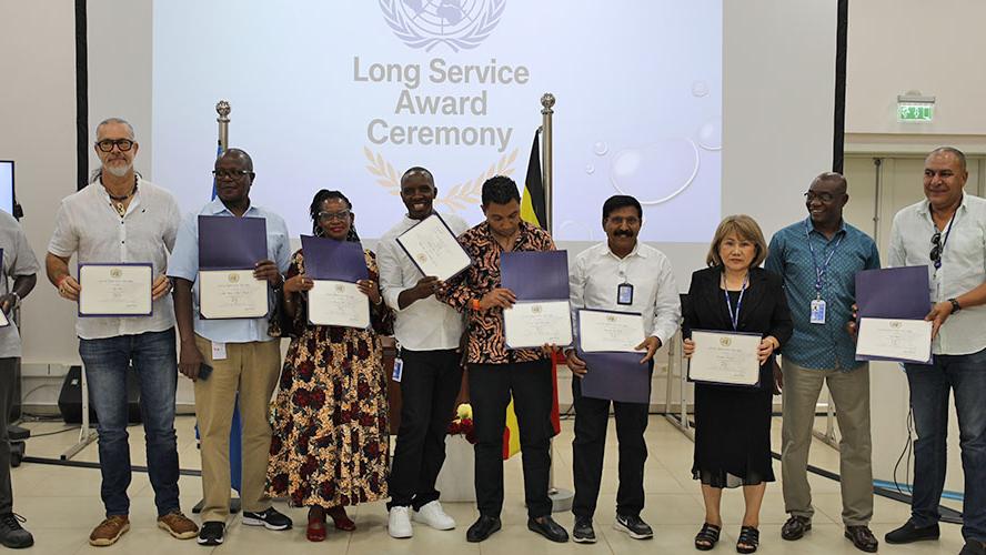 Photo of the recipients of the SG's Long Service Awards posing with their certificates at the RSCE