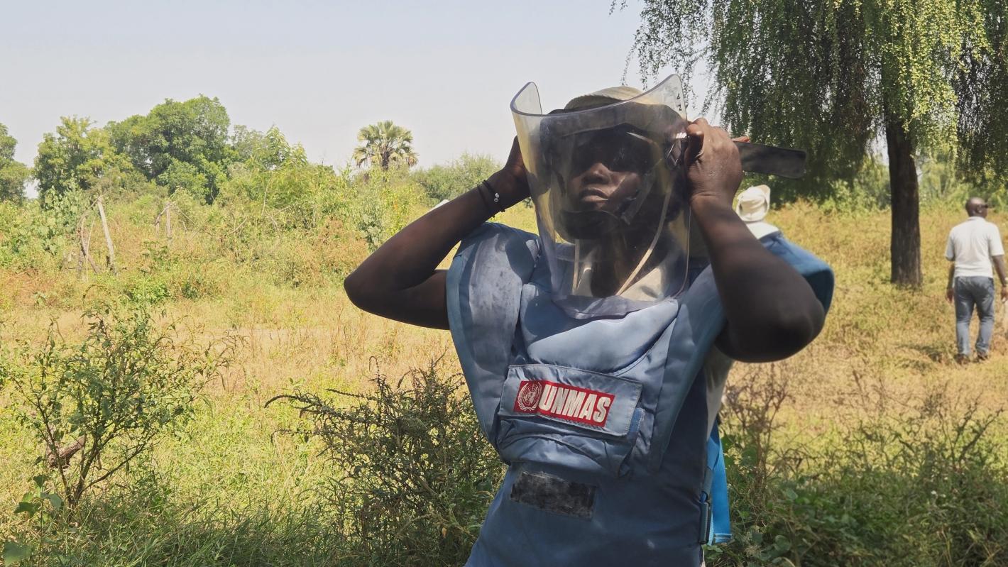 a female deminer with a protective mask
