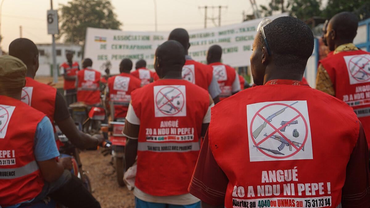 some men's back with red vests