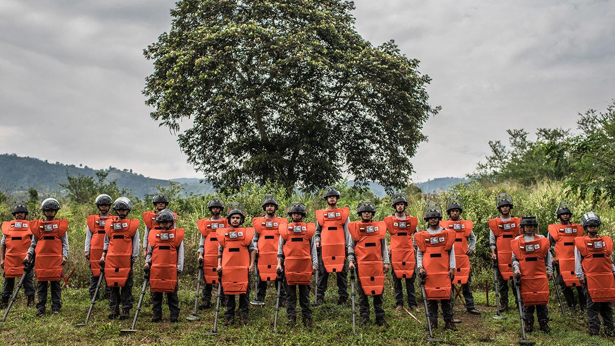 a group of deminers are standing in line