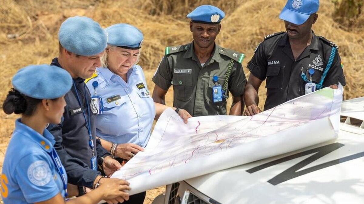 Police officers deployed to the UN peacekeeping mission in South Sudan consult a map