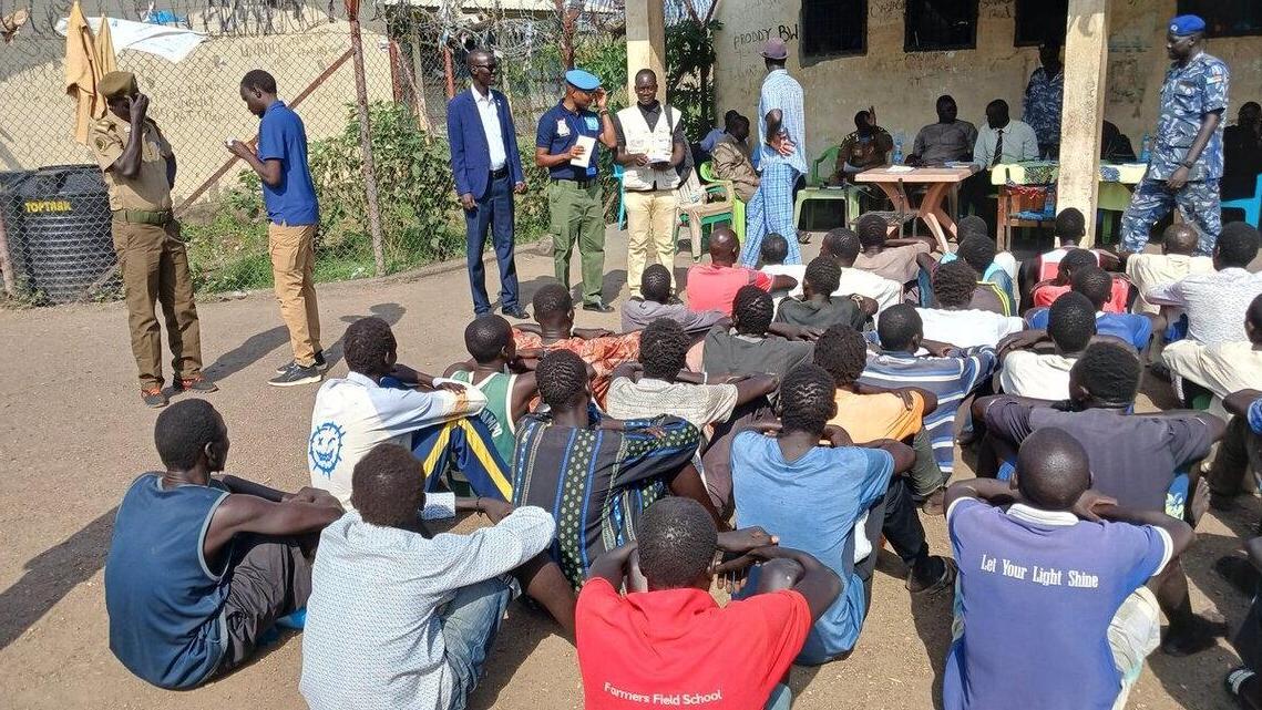 group of people sitting on the ground.