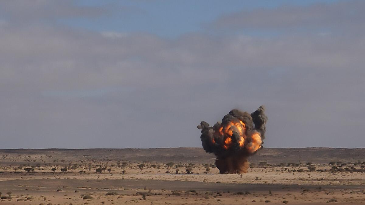 an explosion with smoke in a field