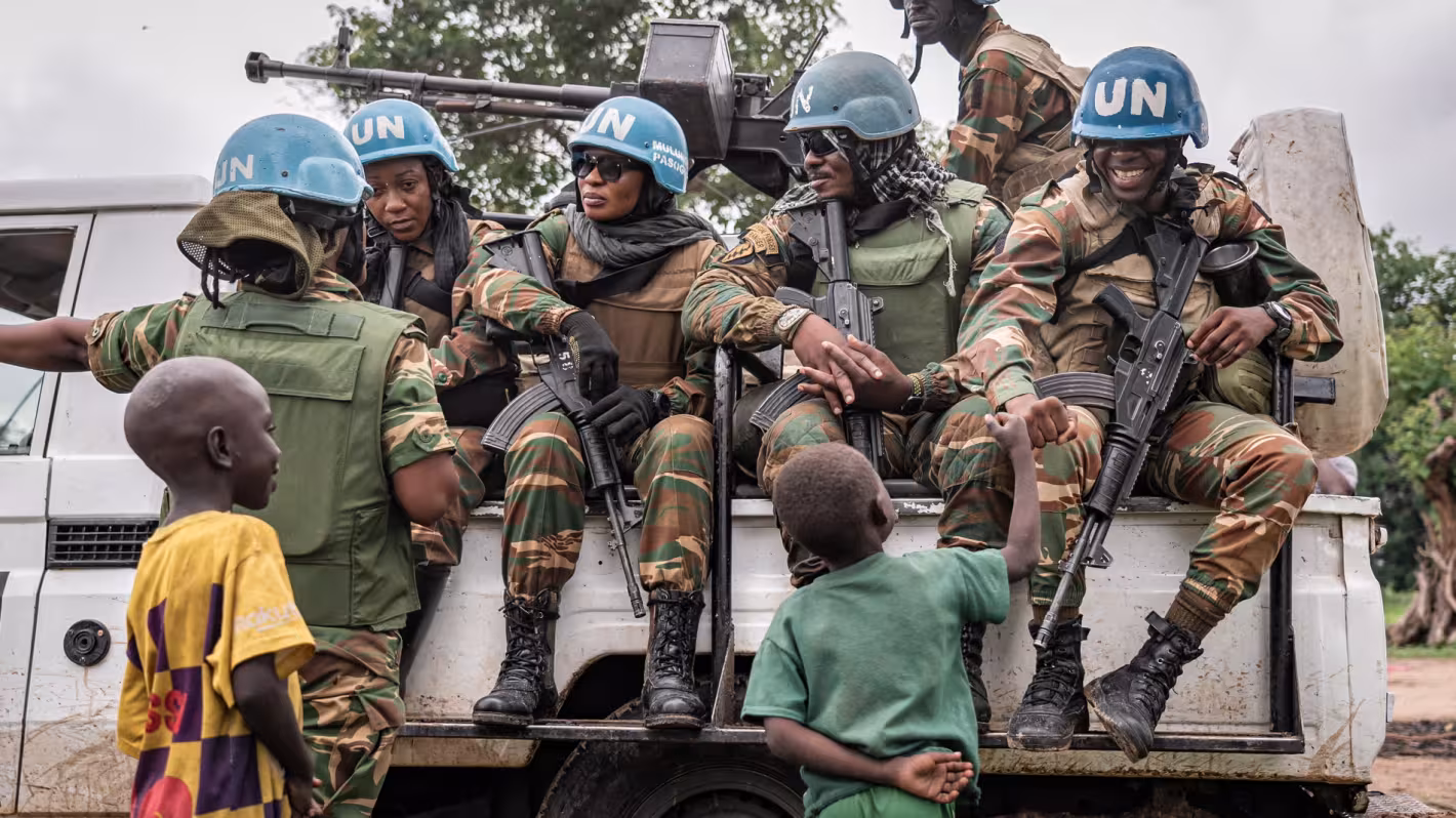 Peacekeepers in a UN truck engage with children.