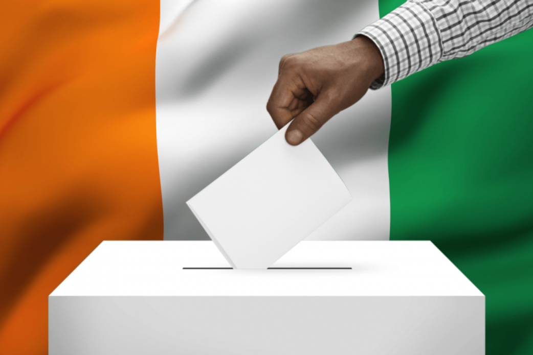 Hand placing a ballot in the ballot box