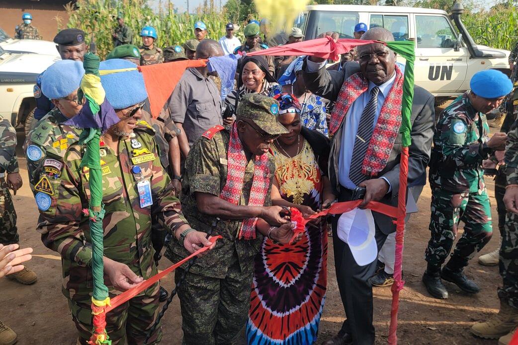 Representatives cut a commemorative ribbon together.