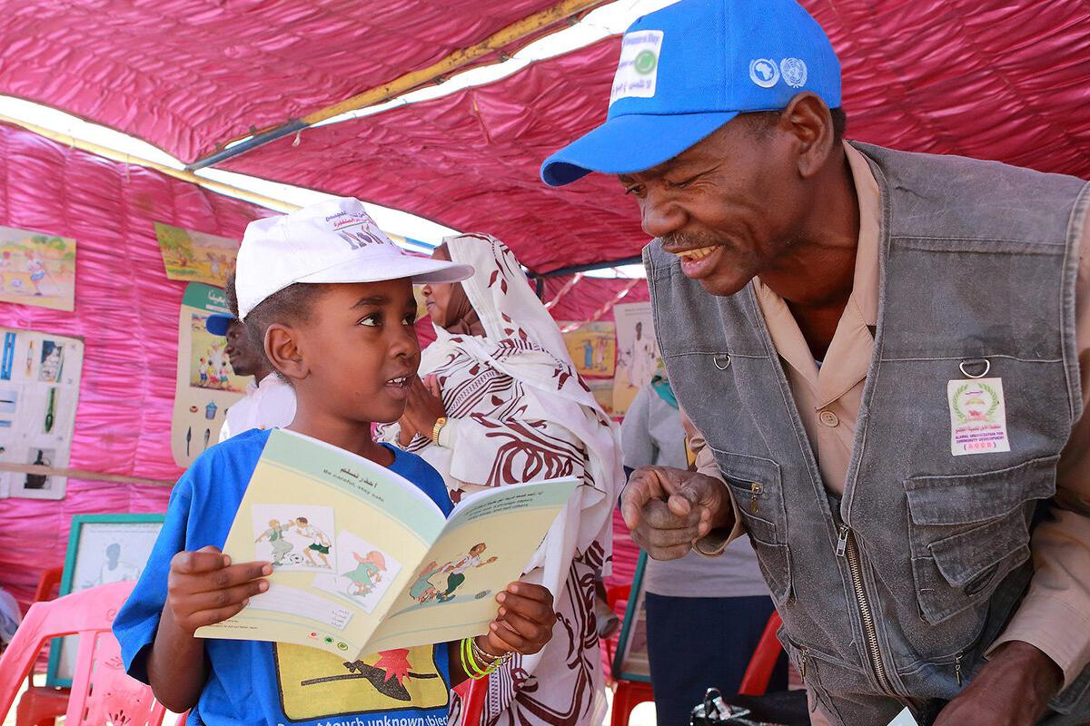 a man is talking to a boy
