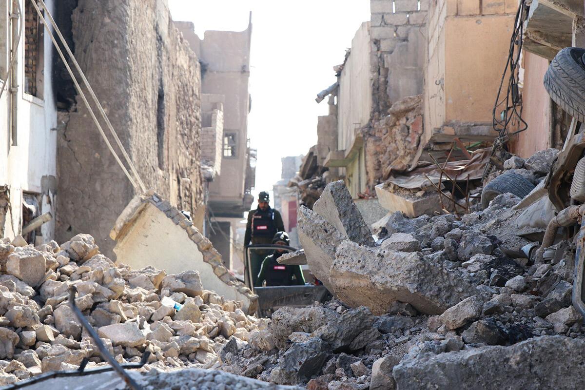 An UNMAS team in war-torn Mosul, Iraq, searches for, and clears, explosives in the rubble. Items hidden could be undetonated bombs, booby traps or suicide vests. Slow and dangerous work. 