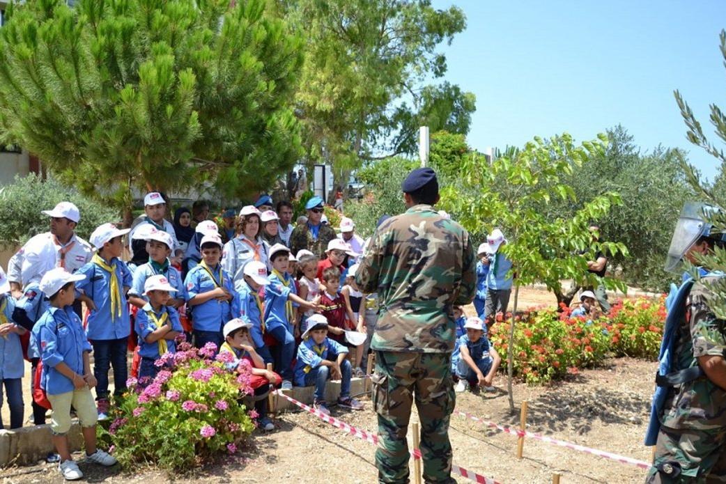Peacekeepers address a group of children.