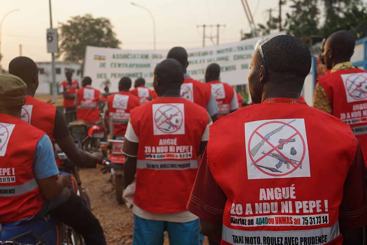 some men's back with red vests
