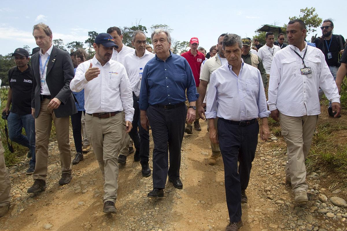 a group of men are walking in a field