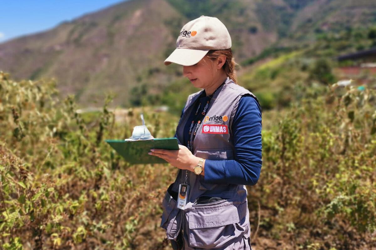 a women with a cap is recording something