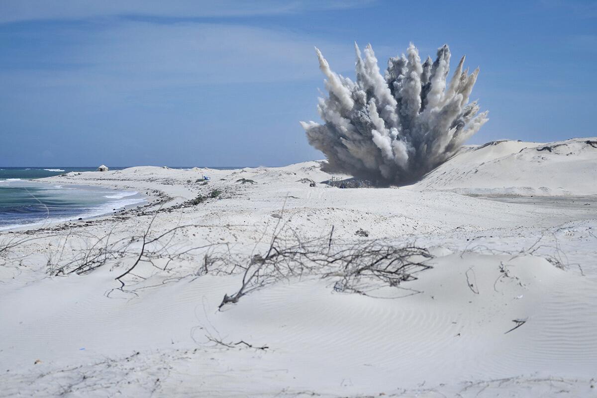 an explosion with smoke in a field