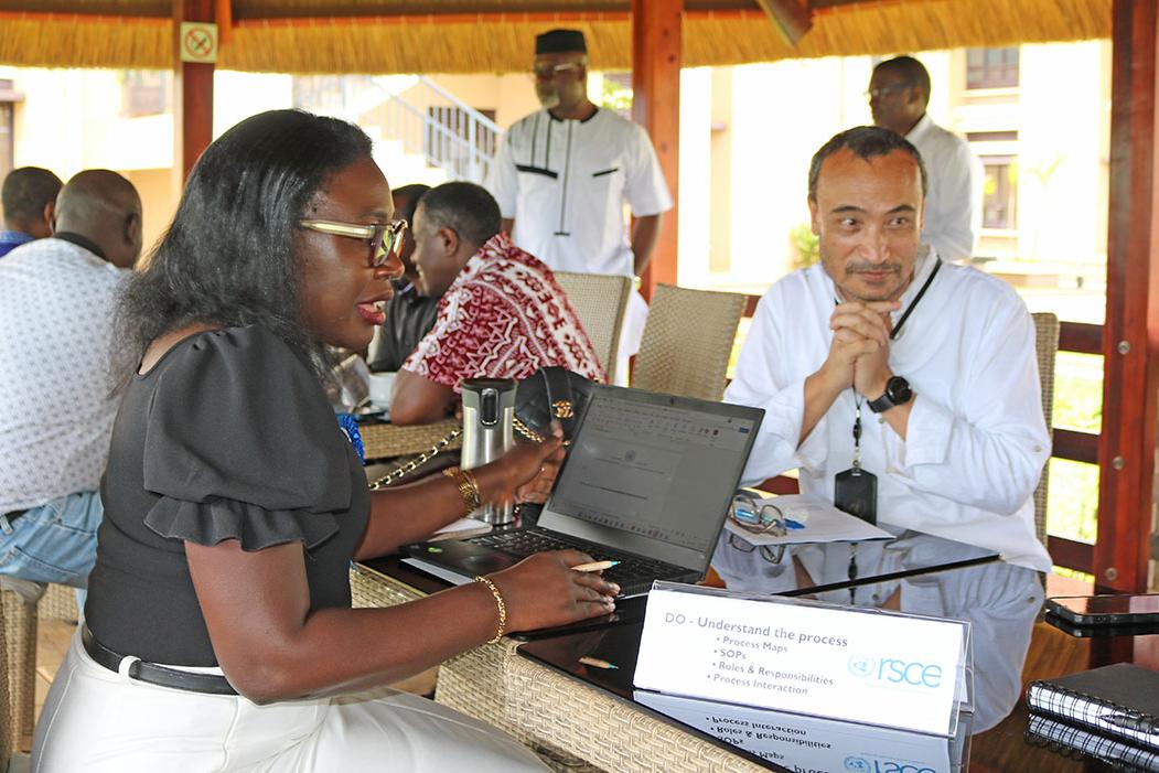 Chief LARRMU, Elise Metougue takes International Payroll and Benefits Service Line Manager, Manaswee Vaidya, through his checklist for ISO 9001:2015 documentation