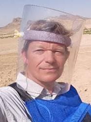 a man's headshot with protective mask