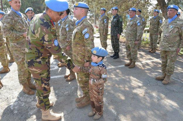 Major General Humayun of Bangladesh, Force Commander of UN Peacekeeping Force in Cyprus (UNFICYP) shaking hands of boy (UN peacekeeper-in-training) at sector 1 medal parade on 31 January 2018, Cyprus. Photo: UNFICYP/Robert Schütz