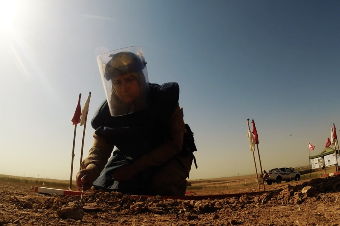 a woman with a hijab and a protective mask
